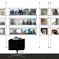 Multiple Abstract Paintings Hung on Wall with Spiral and Cityscape Patterns and Black Cabinet Below