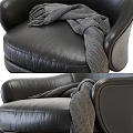 Luxurious Black Leather Accent Chair With Matching Ottoman And Wool Blanket