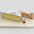 Artisanal Cheese Wedge On Wooden Cutting Board With Leather String Knife
