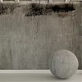 Concrete Sphere Component With Cracked Surface Against Textured Gray Wall With Black Stains