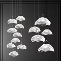 Modern Transparent Chandeliers With Organic Shapes Hanging Against Black Background