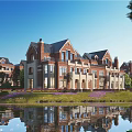 Luxury Detached Villa Featuring Brick Beige Exterior Gabled Roof Lush Lawn Purple Flowers Pond Reflection