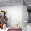 Modern Window Display Merchandising With Art Sculptures Display Tables Green Plants And Lighting Design