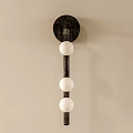 Modern Dark Metal Wall Lamp with Three White Spherical Lampshades on Light Colored Wall