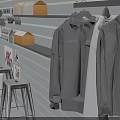 Gray Wall Retail Display With Hanging Shirts Orange Boxes And Stools