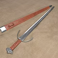 Medieval Sword With Leather Hilt Silver Metal Blade And Leather Scabbard On Beige Fabric Background