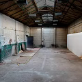 Abandoned Industrial Space Interior With High Ceiling Exposed Brick Walls And Concrete Floor