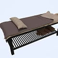 Comfortable Massage Bed With Dark Mat and Pillows Underbed Striped Rack and Brown Towels