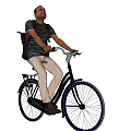 Man riding bicycle in striped shirt with khaki pants and backpack
