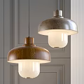 Two Modern Pendant Lights with Wooden and Metallic Shades on Gray Wall