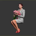 Woman in gray suit holding pink white bouquet wearing pink high heels against gray background