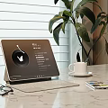 Tablet With Keyboard Stand On Marble Tabletop With Coffee Mug Eyeglasses Magazine And Plant