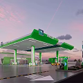 Modern Gas Station Exterior With Green White Canopy Fuel Pumps And Blue Sky
