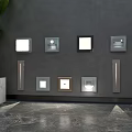 Contemporary Wall Light Fixtures Various Shapes Sizes on Gray Wall with Green Plant Marble Floor