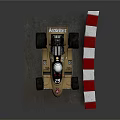 Gold March 761 Race Car With Number 55 Driver And Red White Barriers
