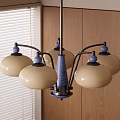 Chandelier with cream colored shades and blue accents above wooden wall with window blinds