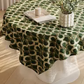 Round Dining Table with Green White Polka Dot Tablecloth White Vase Plants Tray and Candle