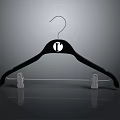 Black Clothes Hanger With Round Logo And White Clips As Household Item