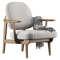 Brown Leather Armchair With Wooden Arms And Gray Throw Blanket