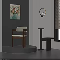 Indoor Corner Design With Gray Wall Beige Chair Wooden Frame Black Table And Artwork