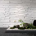 Modern White Textured Wall Panel Design With Decorative Stones And Green Plants