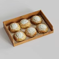 Six fresh homemade cinnamon rolls with powdered sugar displayed in wooden tray
