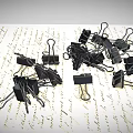 Pile of Black Binder Clips as Practical Daily Supplies on Paper with Text