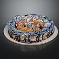 Colorful Layered Ring Pastry With Blue And Orange Swirls On White Plate