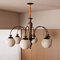 Wooden Chandelier With Metal Arms And Five White Glass Shades In Room With Wooden Cabinets And Window Blinds