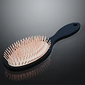 Stylish Hair Comb With Black Handle And Pink Bristles On White Base And Reflective Surface