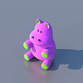 Cute Purple Hippo Doll with Green Ears and Feet Sitting on Gray Surface