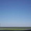 Modern Industrial Factory Building With White Exterior Large Glass Windows And Green Lawn Area
