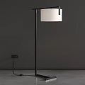 Modern Floor Lamp With Black Metal Stand And White Shade Against Dark Wall