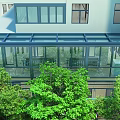 Gym Building with Glass Structure and Indoor Workout Equipment Surrounded by Green Trees