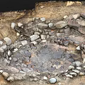 Natural Circular Stone Enclosed Depression With Muddy Ground And Water Puddles