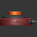 Red Circular Object With Orange Top Button Gray Middle Part And Handle Clasp