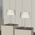 Two Modern Floor Lamps With White Fabric Shades And Metal Stands On White Cube Bases