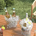 Refreshing Cold Drinks in Ice Buckets with Beer Vodka Bottles Limes on Outdoor Wooden Table