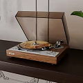 Vintage Turntable With Wooden Base And Clear Cover Playing Gold Vinyl Record On Dark Table