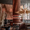 Modern Restaurant Interior With Red Brick Walls Cylindrical Column And Tall Pampas Grass Plants