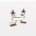 Copper Candle Holders With Curved Spiral Design And Candles On Decorative Base