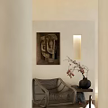 Rattan Leisure Chair in Cozy Interior with Beige Wall Abstract Painting and Black Vase