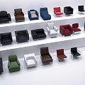 Various Single Sofa Designs In Different Colors Arranged On White Shelves 3d model