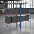 Industrial Shelving With Metal Frame Multiple Levels And Gray Storage Containers In Warehouse