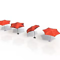 Four Red Umbrellas Displayed On White Background With Metal Stands