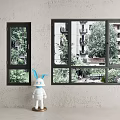 Two Black Frame Windows With Outside Trees Buildings And White Doll With Blue Rabbit Ears