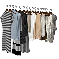 Various Fashionable Clothes Hanging On Hangers With Striped And Solid Color Styles