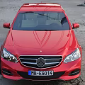 Red Mercedes Benz Sedan With Modern Sleek Exterior And Alloy Wheels