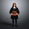 A man in black robe with white collar holding golden intricate object against gray background