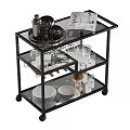 Stylish Black Serving Cart With Glass Shelves Plates Glasses And Magazine